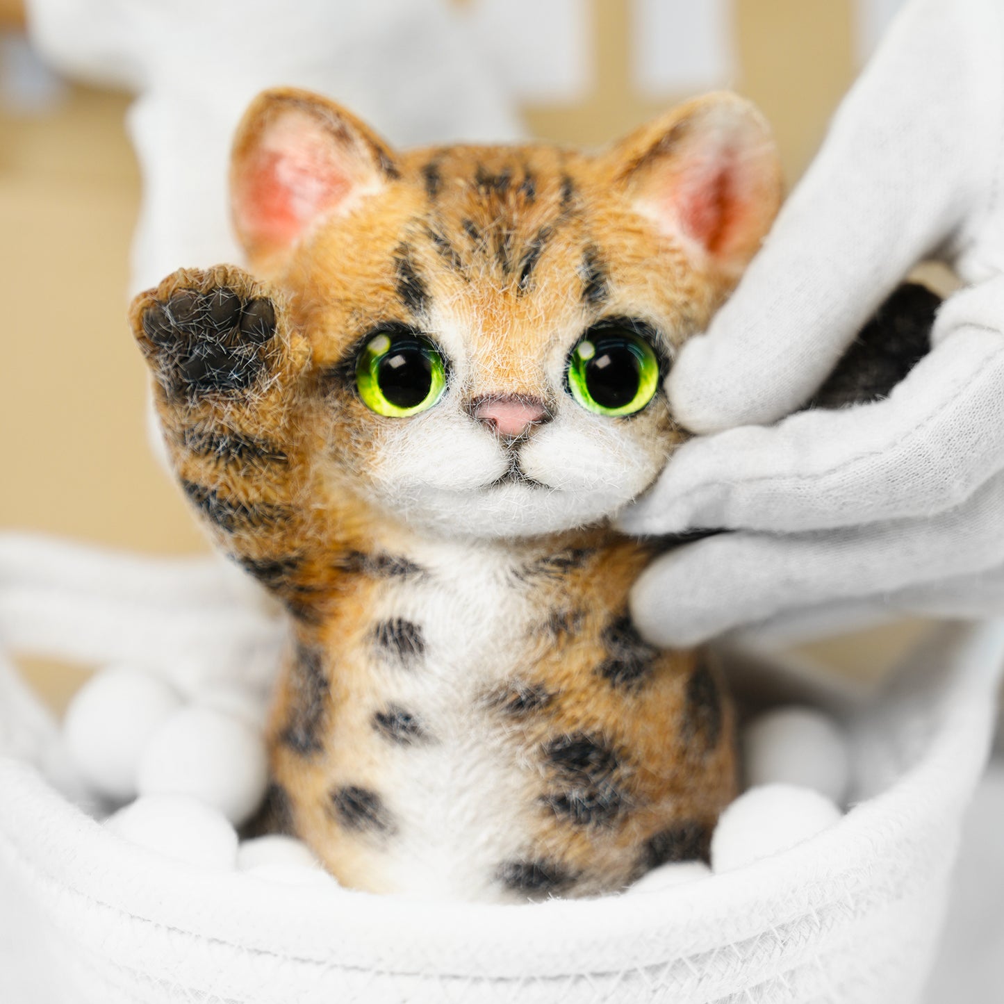 Yellow Tabby Cat handmade squishy toy with green eyes and raised paws, made of soft material.