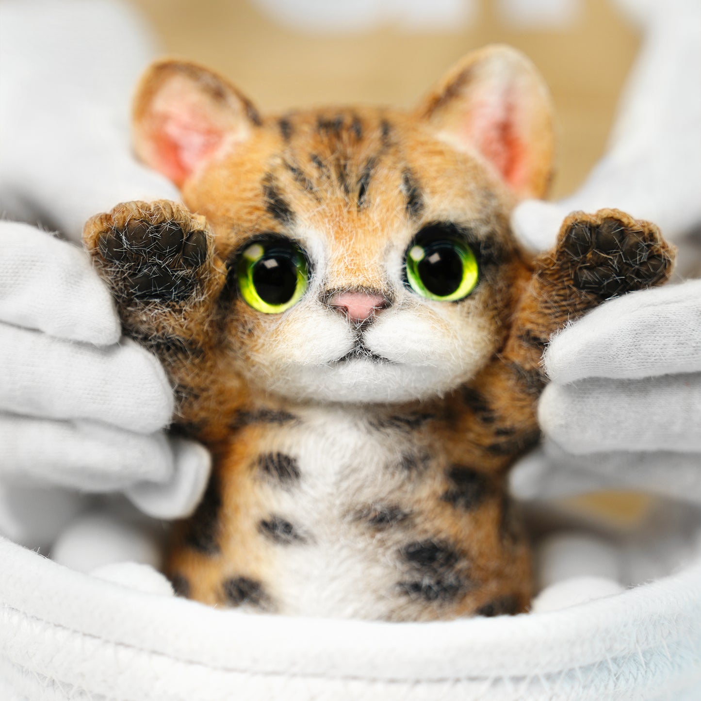 Yellow Tabby Cat handmade squishy toy with green eyes and raised paws, made of soft material.