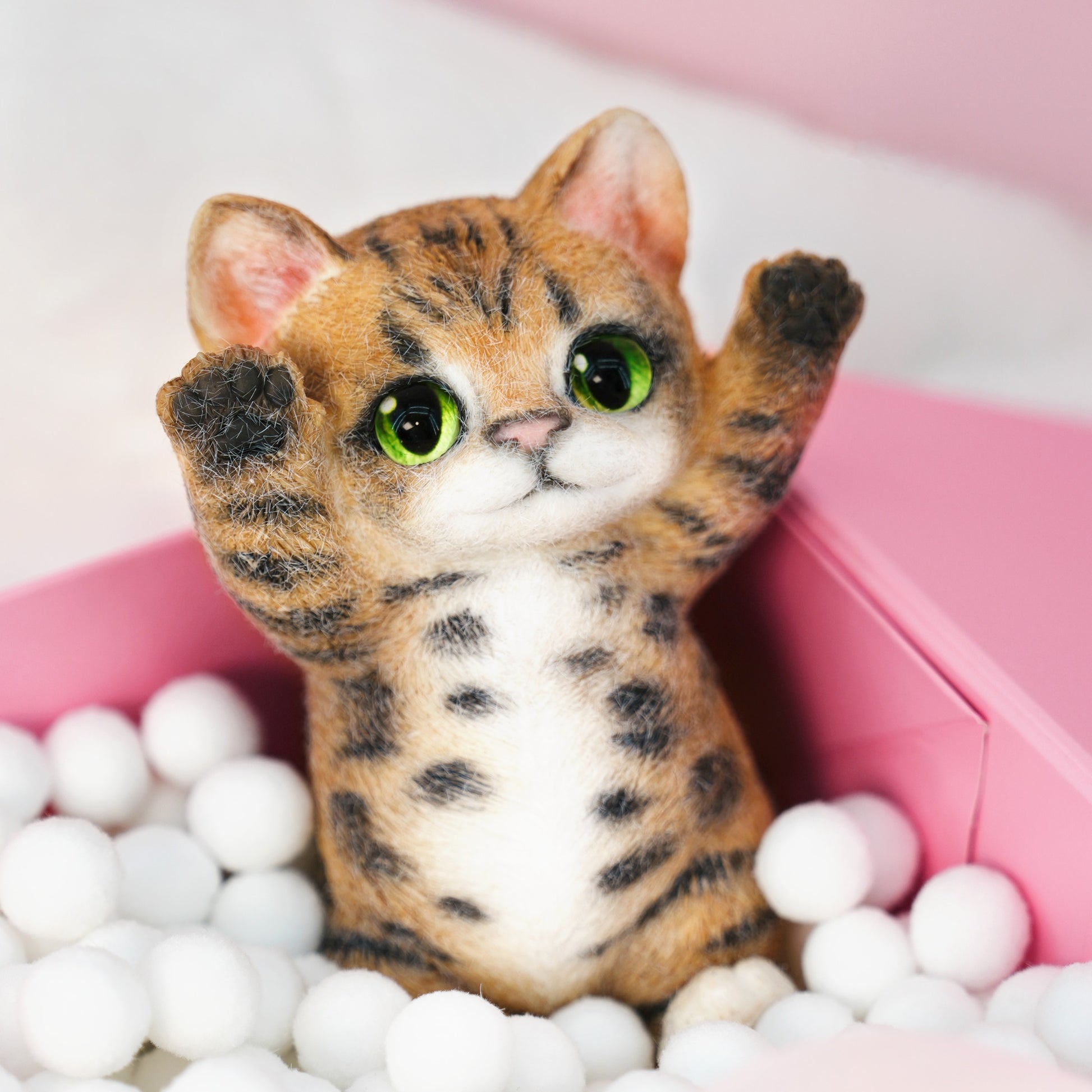 Yellow Tabby Cat handmade squishy toy with green eyes and raised paws, made of soft material.