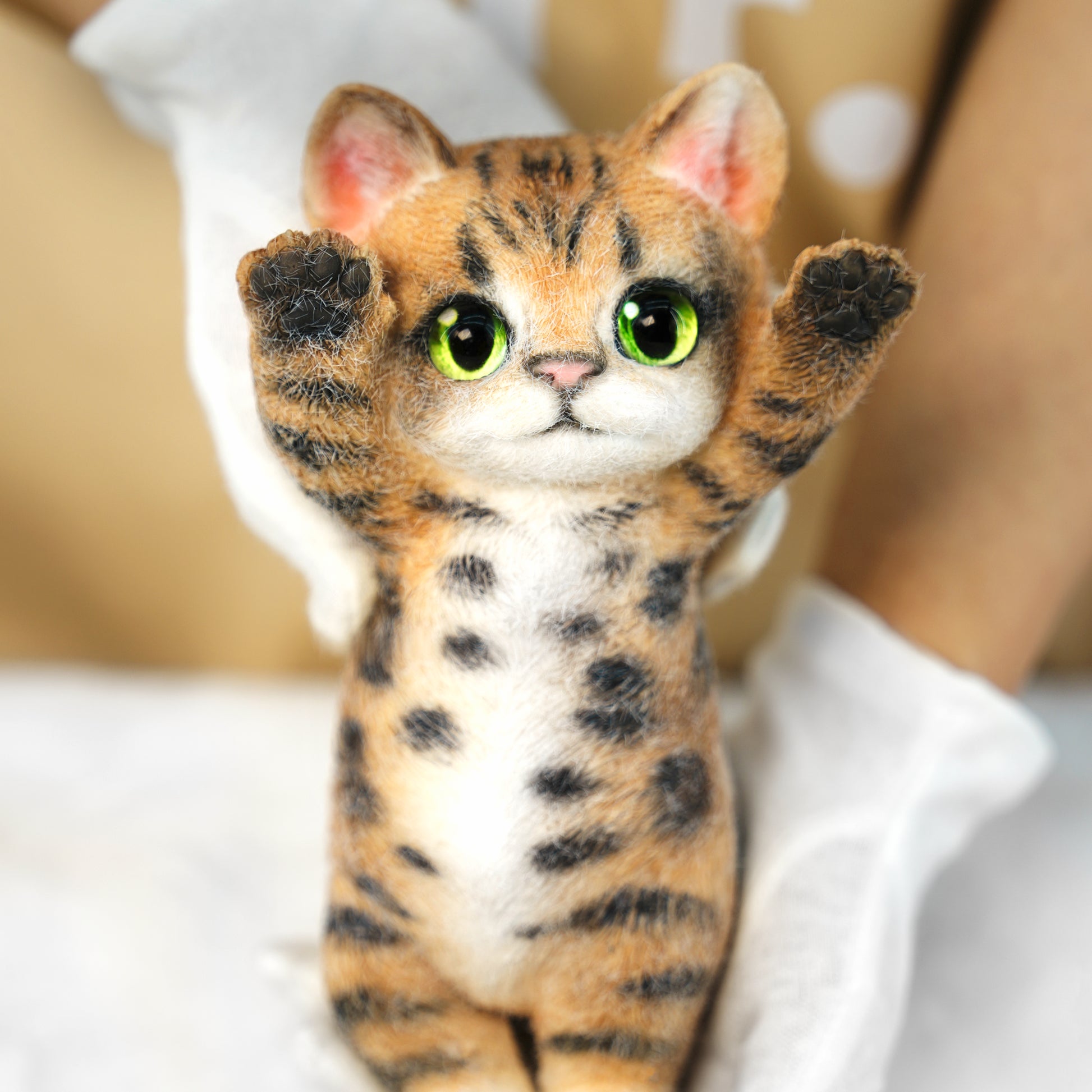 Yellow Tabby Cat handmade squishy toy with green eyes and raised paws, made of soft material.
